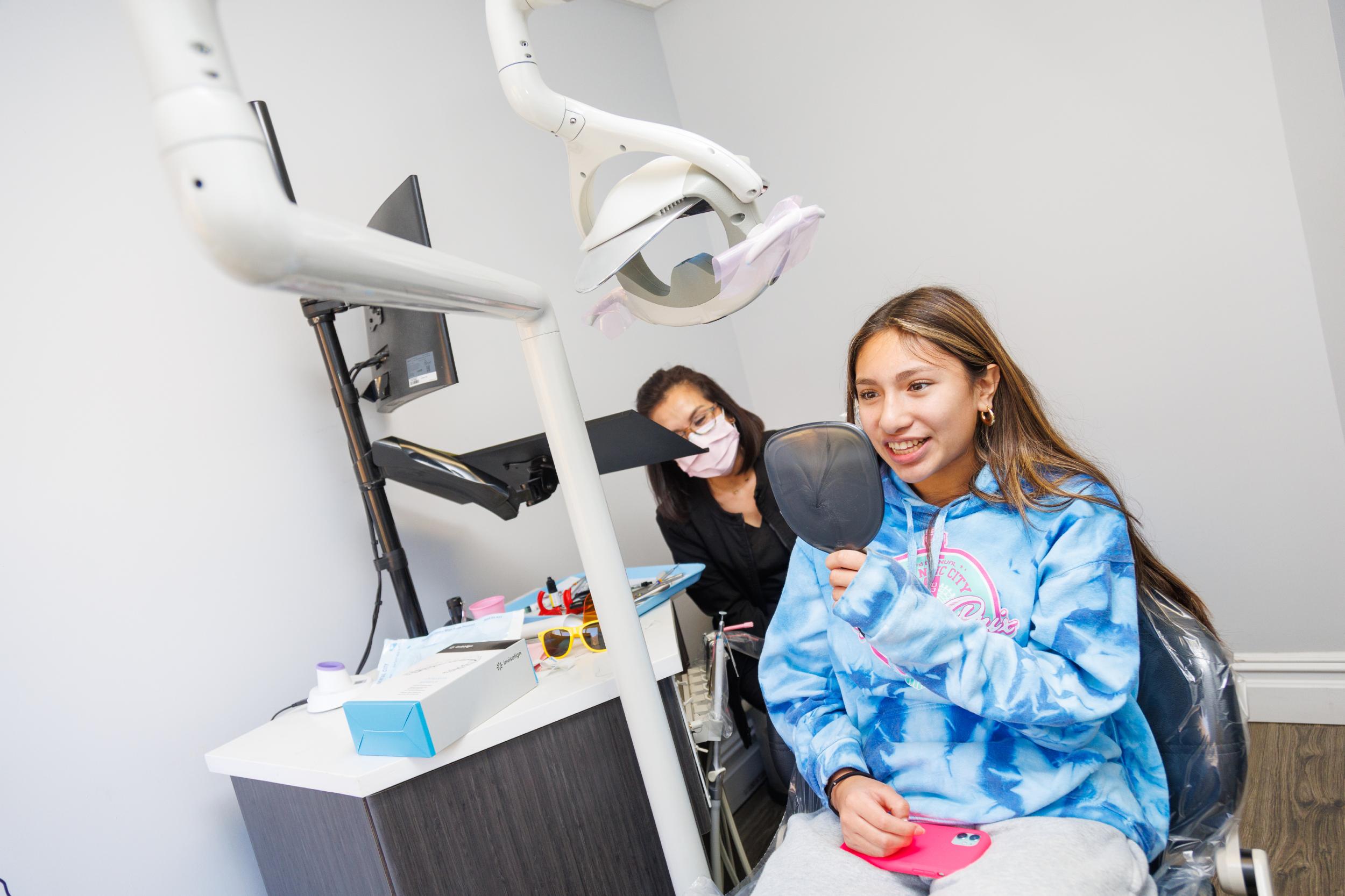 happy patient looking at mirror