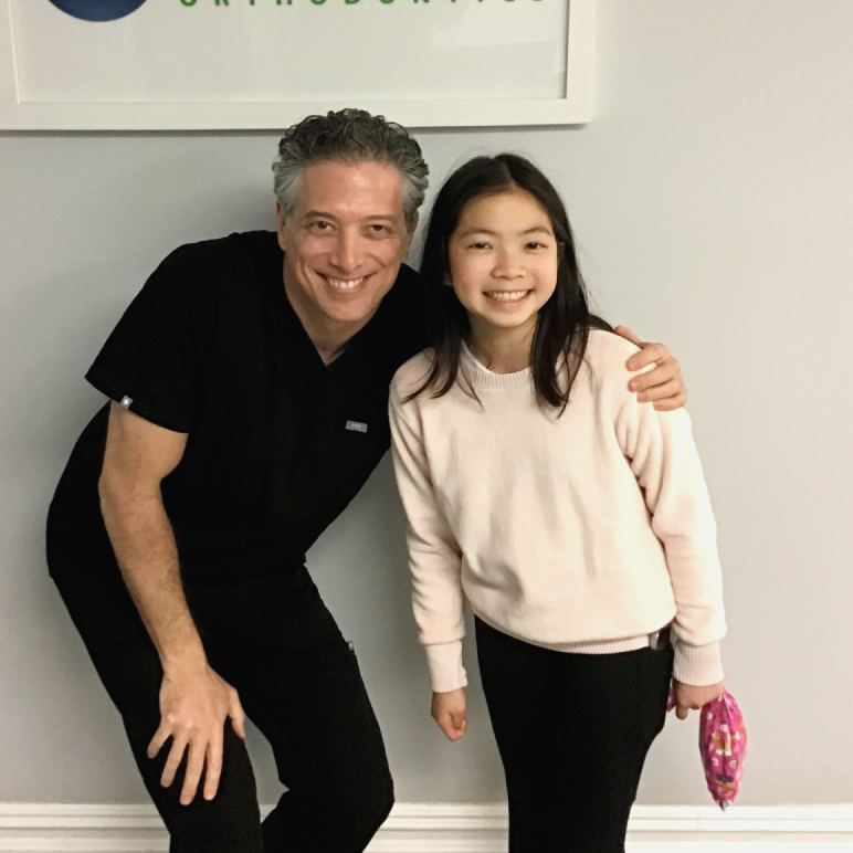 orthodontist with smiling patient